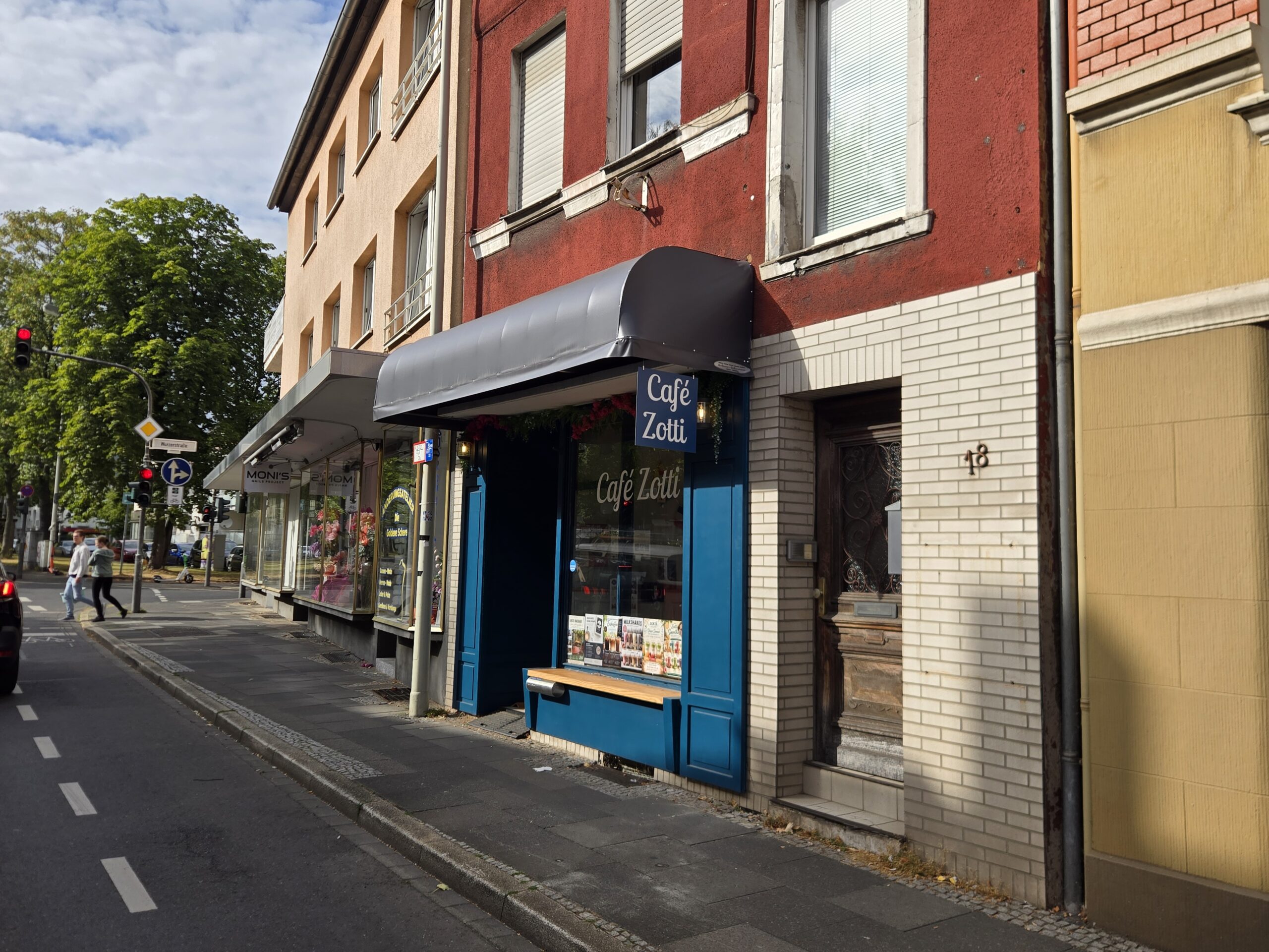 The Cafe is the 4th shop on your left